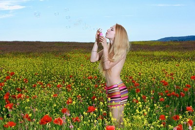 Sweet and charming blonde Kendell showcasing her slim body outdoors in flower field  in Metart set Beaming Blonde