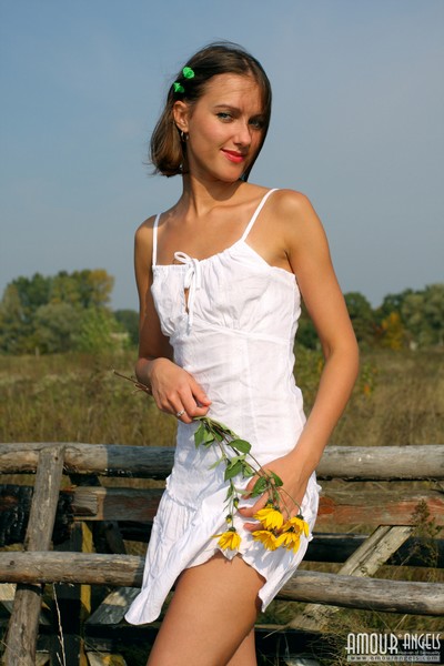 Attractive babe Alina plays with her neat white dress while posing outdoors  in Amour Angels set Romantic Story